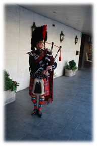 A person playing bagpipes in a building

Description automatically generated